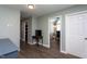 Inviting hallway featuring wood floors, neutral paint, and easy access to a home office at 1009 Open Field Dr, Garner, NC 27529