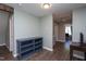 Bright hallway with wood flooring and custom built in shelving and access to multiple rooms at 1009 Open Field Dr, Garner, NC 27529