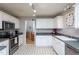 Updated kitchen featuring white cabinets, stainless appliances and a view into the breakfast nook and dining area at 1009 Open Field Dr, Garner, NC 27529