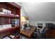 Functional home office featuring custom dark wood shelves, task lighting and an ergonomic chair at 1009 Open Field Dr, Garner, NC 27529