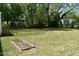 Spacious backyard with a small garden and mature trees, offering a serene outdoor space at 102 Allen St, Graham, NC 27253