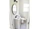Compact bathroom with a new vanity, oval mirror, and updated fixtures at 102 Allen St, Graham, NC 27253