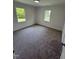 Clean, carpeted bedroom with natural light from two windows, freshly painted white walls at 102 Allen St, Graham, NC 27253
