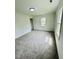 Neat bedroom with clean carpets, fresh white paint, and bright natural light from two windows at 102 Allen St, Graham, NC 27253