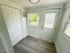 Bright entryway featuring gray wood floors, white walls, closet, door to the outside, and natural light at 102 Allen St, Graham, NC 27253