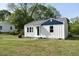 Charming home with a crisp white exterior and a well-manicured lawn at 102 Allen St, Graham, NC 27253