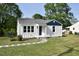 Beautifully renovated home with a crisp white exterior and a well-kept lawn at 102 Allen St, Graham, NC 27253