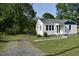 Well-maintained home with a white exterior, surrounded by a green lawn at 102 Allen St, Graham, NC 27253