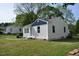 Quaint home with blue and white exterior, complemented by a lush green lawn at 102 Allen St, Graham, NC 27253
