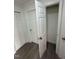 Hallway featuring gray wood floors and access to a closet at 102 Allen St, Graham, NC 27253