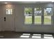Bright living room with large windows, gray floors, and neutral walls at 102 Allen St, Graham, NC 27253