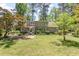 Backyard view showing a home's exterior, landscaped yard, and patio area with ample green space at 103 E Meadowbrook Dr, Smithfield, NC 27577