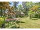 Expansive backyard showcases a brick patio, screened-in porch, and mature trees, providing privacy and shade at 103 E Meadowbrook Dr, Smithfield, NC 27577
