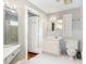 White bathroom featuring classic tile, two sinks, and open doorway to the toilet and shower at 103 E Meadowbrook Dr, Smithfield, NC 27577
