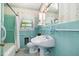 Bathroom featuring turquoise tile, floral wallpaper, and a sink with vanity and toilet at 103 E Meadowbrook Dr, Smithfield, NC 27577