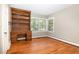 Bright bedroom with hardwood floors, built-in shelving, and an abundance of natural light at 103 E Meadowbrook Dr, Smithfield, NC 27577