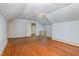 Attic bedroom with hardwood floors, a window with natural light, and two closets for storage at 103 E Meadowbrook Dr, Smithfield, NC 27577