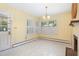 Bright dining room with neutral tones, corner windows, and classic chandelier at 103 E Meadowbrook Dr, Smithfield, NC 27577