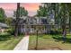 Charming two-story home with a landscaped front yard and dormer windows at sunset at 103 E Meadowbrook Dr, Smithfield, NC 27577