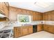 Traditional kitchen with wooden cabinetry, laminate countertops, and essential appliances at 103 E Meadowbrook Dr, Smithfield, NC 27577