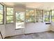 Sunroom surrounded by windows and a door to the back, with concrete flooring and white trim at 103 E Meadowbrook Dr, Smithfield, NC 27577