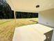 Covered back porch overlooking expansive backyard and lush trees, perfect for outdoor living at 107 Earnest Way, Kenly, NC 27542