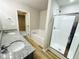 Elegant bathroom with granite-topped double vanity, soaking tub, and glass shower at 107 Earnest Way, Kenly, NC 27542