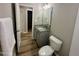 En suite bathroom with granite countertops, a single sink vanity, and a door to the bedroom at 107 Earnest Way, Kenly, NC 27542