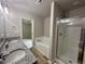 Bathroom boasting dual sinks with granite countertops, a separate tub, and a glass-enclosed shower at 107 Earnest Way, Kenly, NC 27542