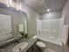 Bathroom showcases a vanity with granite countertop, a single sink, and a shower and bathtub combination at 107 Earnest Way, Kenly, NC 27542