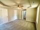 Expansive carpeted bedroom showcasing a tray ceiling, fan, and multiple doorways at 107 Earnest Way, Kenly, NC 27542