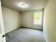 Cozy carpeted bedroom with a bright window and neutral paint at 107 Earnest Way, Kenly, NC 27542