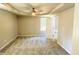 Spacious carpeted bedroom with tray ceiling, ceiling fan, and natural light at 107 Earnest Way, Kenly, NC 27542