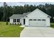 Charming single-Gathering home featuring a two-car garage, well-manicured lawn, and classic architectural details at 107 Earnest Way, Kenly, NC 27542