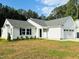 Beautiful home with attached garage, manicured lawn, and black shutters on the windows at 107 Earnest Way, Kenly, NC 27542