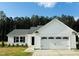 Charming single-Gathering home featuring a two-car garage, landscaped yard, and classic exterior design at 107 Earnest Way, Kenly, NC 27542