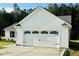 This home boasts a well-maintained two-car garage with black hardware and white siding at 107 Earnest Way, Kenly, NC 27542