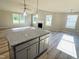 Kitchen with large island and open access to the living space at 107 Earnest Way, Kenly, NC 27542