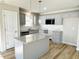 Modern kitchen with grey cabinets, granite countertops, and stainless-steel appliances at 107 Earnest Way, Kenly, NC 27542