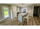 Kitchen featuring a gray island with a stone countertop, stainless steel appliances, and gray cabinets at 107 Earnest Way, Kenly, NC 27542