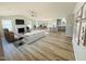 Bright, open-concept living space with fireplace, large windows, and adjacent kitchen with bar seating at 107 Earnest Way, Kenly, NC 27542