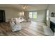 Inviting living room with fireplace, wood-look flooring, and comfortable seating for a cozy and relaxing space at 107 Earnest Way, Kenly, NC 27542
