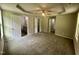 Large main bedroom showing ceiling fan, carpeted floors, doors to the bathroom and closets, and a tray ceiling at 107 Earnest Way, Kenly, NC 27542