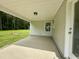 Rear porch featuring a concrete floor, a ceiling light, and a view of the backyard, perfect for relaxation at 107 Earnest Way, Kenly, NC 27542