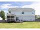 Expansive backyard with an outdoor deck, screened-in porch, and lush green lawn at 110 Stoney Dr, Durham, NC 27703