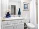 Well-lit bathroom with a white vanity, framed mirror, and a combined shower and tub at 110 Stoney Dr, Durham, NC 27703