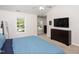 Bright bedroom featuring a large window, neutral walls, a ceiling fan and an expansive dresser at 110 Stoney Dr, Durham, NC 27703