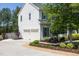 Traditional two-story home with a two-car garage, lush landscaping, and a concrete driveway at 110 Stoney Dr, Durham, NC 27703