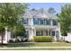 Charming two-story home featuring light siding, green shutters, a manicured lawn and mature landscaping at 110 Stoney Dr, Durham, NC 27703