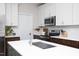 Modern kitchen featuring stainless steel appliances, a large island, and stylish fixtures at 110 Stoney Dr, Durham, NC 27703